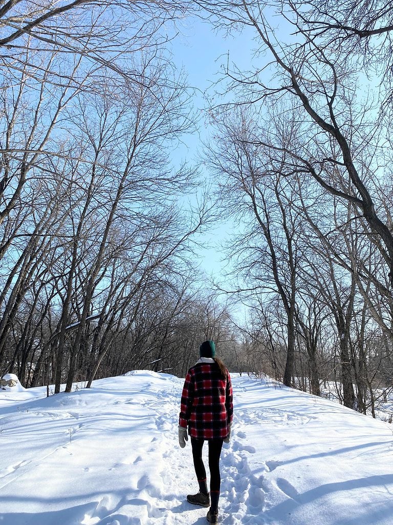 Walking down a snowy covered path in the winter