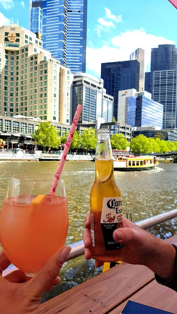 Cheersing happy hour drinks along the Yarra River