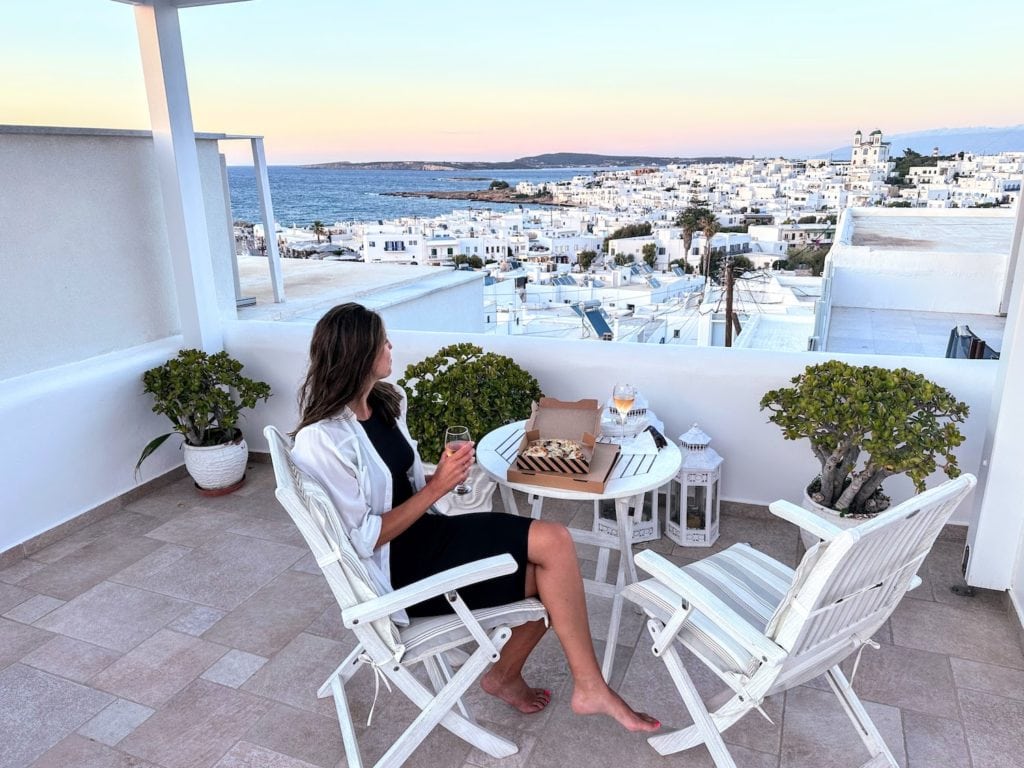 wearing a linen cover up on a rooftop patio in Paros, Greece
