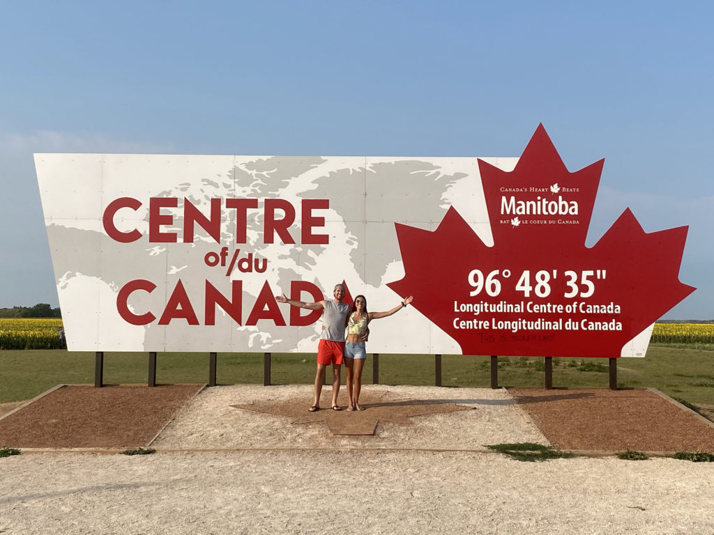 Things to do in Winnipeg - couple standing in front of the centre of canada sign in Manitoba